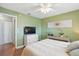 Comfortable bedroom with a ceiling fan, wood floors and a large window with natural light at 4358 Pates St, Port Charlotte, FL 33948