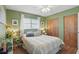 Comfortable bedroom with a ceiling fan, wood floors and a large window with natural light at 4358 Pates St, Port Charlotte, FL 33948