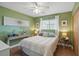 Comfortable bedroom with a ceiling fan, wood floors and a large window with natural light at 4358 Pates St, Port Charlotte, FL 33948