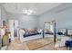 Bright bedroom featuring daybed, ceiling fan, and large mirror reflecting the room's decor at 4358 Pates St, Port Charlotte, FL 33948