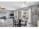 Dining room with a round table and view of the backyard through large windows at 4358 Pates St, Port Charlotte, FL 33948