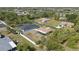 Scenic aerial shot showcasing the home, fenced yard, and surrounding trees in the neighborhood at 4358 Pates St, Port Charlotte, FL 33948