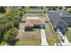 Aerial view showcasing the home's facade, manicured lawn, driveway, and well-maintained landscaping at 4358 Pates St, Port Charlotte, FL 33948