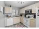 Bright kitchen features tile flooring, white cabinetry, and modern appliances at 4358 Pates St, Port Charlotte, FL 33948