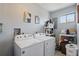Laundry room with a side by side washer and dryer and storage shelves at 4358 Pates St, Port Charlotte, FL 33948