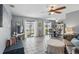 Spacious living area with tile floors, ceiling fan, and sliding glass doors leading to the backyard at 4358 Pates St, Port Charlotte, FL 33948