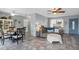 Cozy living room with neutral tile flooring, ceiling fans, and a decorative front door at 4358 Pates St, Port Charlotte, FL 33948