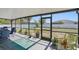 Screened-in patio with seating area, offering a view of the backyard and garden at 4358 Pates St, Port Charlotte, FL 33948