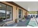 Covered patio with multiple seating areas, providing a relaxing outdoor space at 4358 Pates St, Port Charlotte, FL 33948
