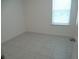 Bright, tiled bedroom featuring neutral walls and natural light from window at 4830 Cazes Ave, North Port, FL 34287