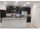 Modern kitchen featuring stainless steel appliances, granite countertops, and dark cabinetry at 4830 Cazes Ave, North Port, FL 34287