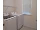 Functional laundry room equipped with Samsung washer and dryer and overhead shelving at 4830 Cazes Ave, North Port, FL 34287