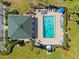 Aerial view of community pool with ample lounge chairs and well-manicured landscaping at 601 Shreve St # 53C, Punta Gorda, FL 33950