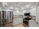 Kitchen featuring stainless steel appliances, granite countertops, and white cabinetry at 601 Shreve St # 53C, Punta Gorda, FL 33950