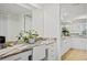 Bright vanity with marble countertop, white cabinets, and mirror at 601 Shreve St # 53C, Punta Gorda, FL 33950