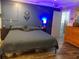 Bedroom with wood-look floors, ample space, and access to the en-suite bathroom at 6421 Grove Blvd, Punta Gorda, FL 33982