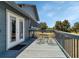 View of outdoor deck with metal table and chairs and backyard views at 6421 Grove Blvd, Punta Gorda, FL 33982