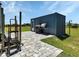 Storage container with a patio, and a grill, sitting on a grassy area at 6421 Grove Blvd, Punta Gorda, FL 33982