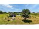 Exterior of building next to a pond and shaded by a big tree at 6421 Grove Blvd, Punta Gorda, FL 33982