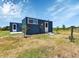 Containers with a patio, exterior door, and grassy area at 6421 Grove Blvd, Punta Gorda, FL 33982