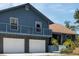 View of home's exterior showcasing the attached garage and landscaped entrance at 6421 Grove Blvd, Punta Gorda, FL 33982
