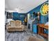 Inviting living room featuring stylish gray floors, a comfortable leather couch, and unique wall decor at 6421 Grove Blvd, Punta Gorda, FL 33982