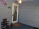 Covered porch features a shoe rack, welcome sign, an umbrella, and unique decorative touches at 6421 Grove Blvd, Punta Gorda, FL 33982