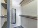 Organized walk-in closet featuring a mirror, shelves, and hanging rods for efficient storage solutions at 6421 Grove Blvd, Punta Gorda, FL 33982
