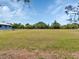 Large grassy yard surrounding building at 6421 Grove Blvd, Punta Gorda, FL 33982