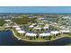 Aerial view of the condos, highlighting waterfront views, community pool, and lush, green surroundings at 1080 Bal Harbor Blvd # 12C, Punta Gorda, FL 33950