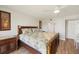 Bedroom with tropical bedding, wood flooring and an adjacent door to another room at 1080 Bal Harbor Blvd # 12C, Punta Gorda, FL 33950