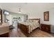 Bright bedroom with a queen bed, ceiling fan, television and sliding glass doors to a lanai at 1080 Bal Harbor Blvd # 12C, Punta Gorda, FL 33950