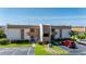 Exterior view of well-maintained condo building with mature landscaping, covered balconies, and parking at 1080 Bal Harbor Blvd # 12C, Punta Gorda, FL 33950