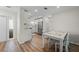 Open-concept dining area with white table and chairs adjacent to modern kitchen at 1080 Bal Harbor Blvd # 12C, Punta Gorda, FL 33950