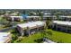 Exterior aerial view of the condo surrounded by landscaped grounds and community pool in the distance at 1080 Bal Harbor Blvd # 12C, Punta Gorda, FL 33950