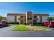 A well-maintained exterior elevation of a two-story condo building with parking and manicured lawn at 1080 Bal Harbor Blvd # 12C, Punta Gorda, FL 33950