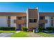 A manicured exterior elevation of a two-story condo building with parking and colorful landscaping at 1080 Bal Harbor Blvd # 12C, Punta Gorda, FL 33950