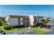 Well-maintained condo building with manicured landscaping and ample parking spaces on a sunny day at 1080 Bal Harbor Blvd # 12C, Punta Gorda, FL 33950