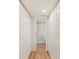 Hallway with access to a bathroom in between a pair of double closets at 1080 Bal Harbor Blvd # 12C, Punta Gorda, FL 33950