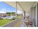 Screened lanai featuring comfortable seating and views of the community pool and landscaping at 1080 Bal Harbor Blvd # 12C, Punta Gorda, FL 33950