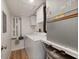Bright laundry room with a washing machine and dryer, storage cabinets, and a utility sink at 1080 Bal Harbor Blvd # 12C, Punta Gorda, FL 33950