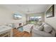 Living room with a large window offering bright light, comfortable sofa, and ceiling fan at 1080 Bal Harbor Blvd # 12C, Punta Gorda, FL 33950