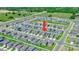 Aerial view of a residential neighborhood showcasing well-maintained homes and green spaces at 111 Rain Lily Ave, Spring Hill, FL 34609