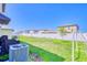 Landscaped backyard with green grass, modern fence and exterior AC unit at 111 Rain Lily Ave, Spring Hill, FL 34609