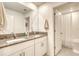 Modern bathroom featuring granite counters, white cabinets, and a double vanity sink at 111 Rain Lily Ave, Spring Hill, FL 34609