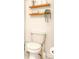 Cozy bathroom featuring a toilet, a floating wood shelf and modern decorations at 111 Rain Lily Ave, Spring Hill, FL 34609