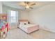 Bedroom featuring a ceiling fan, neutral walls, carpet flooring and a window for natural light at 111 Rain Lily Ave, Spring Hill, FL 34609