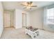 Bright bedroom with neutral carpet, white walls, ceiling fan and a window view at 111 Rain Lily Ave, Spring Hill, FL 34609