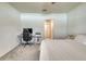 Bright bedroom features a comfortable bed and a functional workspace with a computer setup at 111 Rain Lily Ave, Spring Hill, FL 34609