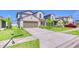 Charming two-story home with a two-car garage, well-maintained lawn, and inviting curb appeal at 111 Rain Lily Ave, Spring Hill, FL 34609